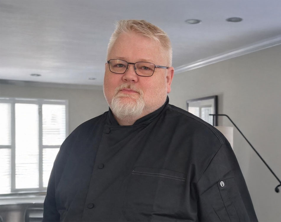 Owner of veteran owned food truck, Mayhem on Wheels , with military background preparing globally inspired comfort food.